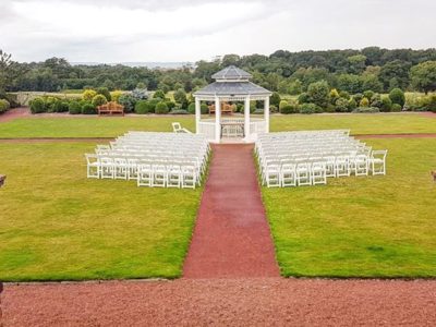 White ceremon chairs with gazebo outdoor weddig ceremony